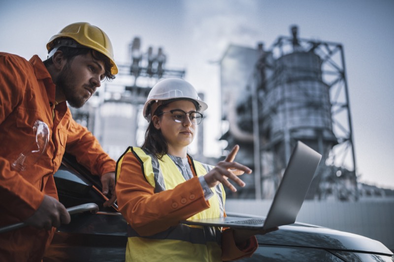 Engineers inspecting machinery in a power plant, symbolizing industrial maintenance